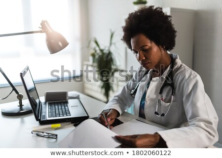 Stock photo: Worried Doctor Looking At Laptop