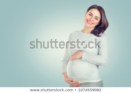 Stok fotoğraf: Smiling Pregnant Woman Caressing Her Belly