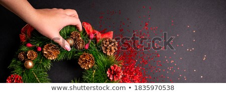 Foto d'archivio: Christmas Wreath Of Golden Stars Over Red Background