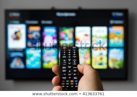 Stok fotoğraf: Male Hand Holding Tv Remote Control