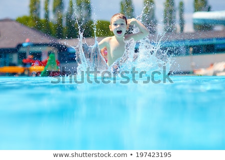 ストックフォト: Jumping Splash Into The Summer Water Pool