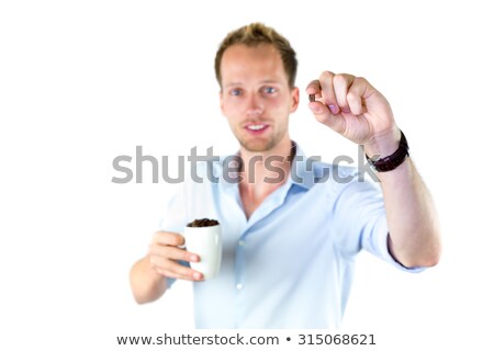 Сток-фото: Young Salesman Holding Cup And Coffee Beans