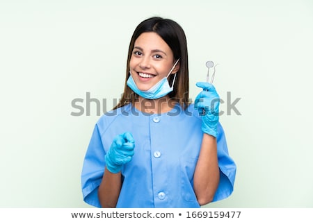 Stok fotoğraf: Happy Dentist Pointing To You At Dental Clinic