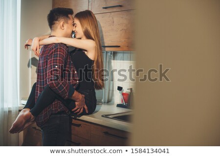 Stockfoto: Young Couple Hugging And Kissing At Kitchen