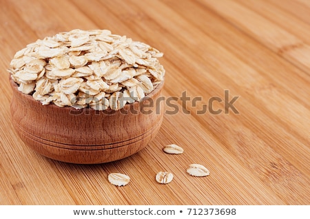Zdjęcia stock: Oat Flake In Wooden Bowl On Brown Bamboo Board Closeup Healthy Dietary Cereals Background