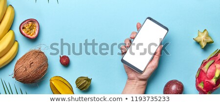 A Variety Of Tropical Fruits And A Female Hand With A Phone On A Stockfoto © artjazz