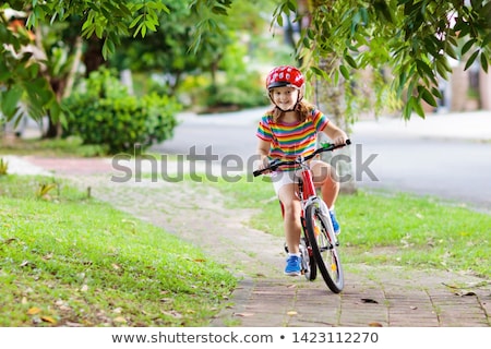 Foto stock: Little Girl Riding A Bike