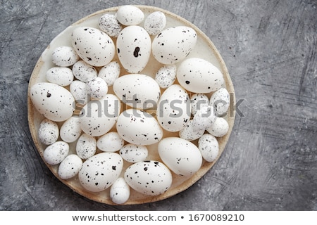 Stockfoto: Composition Of White Traditional Dotted Easter Eggs In White Ceramic Plate