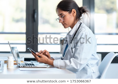Foto d'archivio: Portrait Of A Female Doctor Using Her Laptop Computer At Clinic