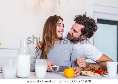 Stock fotó: Happy Couple Chopping Vegetables At Kitchen Counter