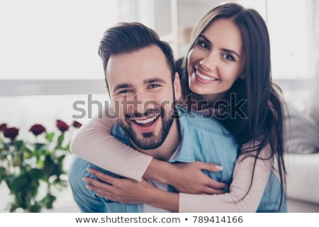 Stok fotoğraf: Happy Young Couple Smiling And Hugging