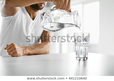 Foto stock: Athletic Young Man Drinking Water