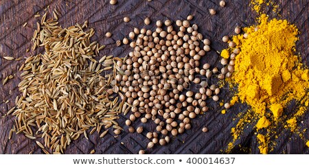 Stockfoto: Assortment Of Spices Cumin Carry Turmeric Coriander Seeds On An Old Wooden Cutting Board