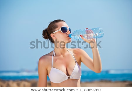 Stock foto: Woman In Bikini With Bottle Of Drink On Beach