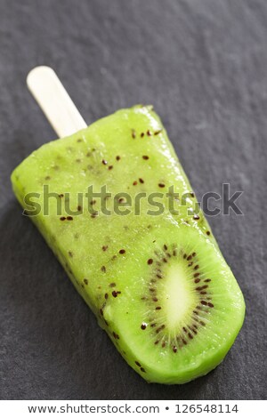 Stockfoto: Fruit Ice Cream On Stick With Slices Fruits On Black