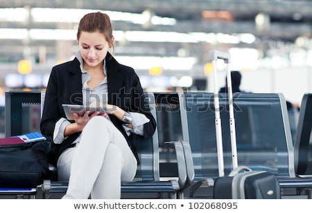 Stock fotó: Young Female Passenger At The Airport Using Her Tablet Computer
