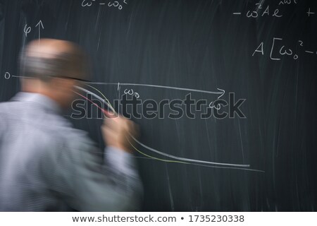 Stock fotó: Math Teacher Drawing Fuction Graph On A Blackboard During Math