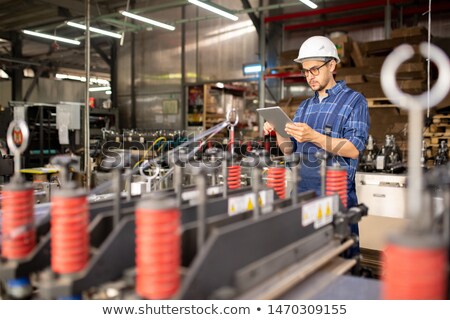 Young Engineer Or Technician With Tablet Searching For Technical Information 商業照片 © Pressmaster