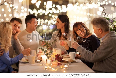 Stockfoto: Family With Sparklers Having Dinner Party At Home