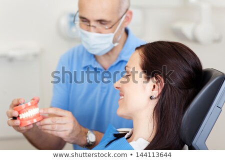 Stock photo: Dentist Doctor Explaining Orthodontic Medical Treatment