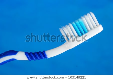 Foto stock: Tooth Brush In Blue Cup Close Up