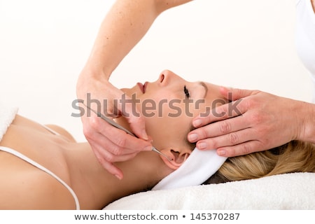 Stock photo: Homeopath Using Ear Acupuncture Techniques