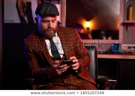 Foto stock: Handsome Businessman Using Smartphone In Pub