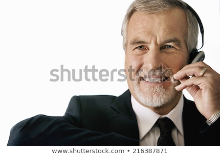 Foto d'archivio: Smiling Mature Man Wearing Headphones Looking Up