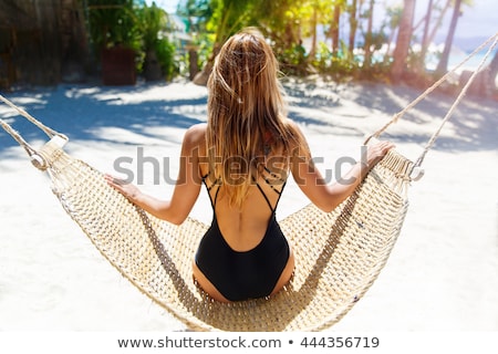 Foto stock: Girl In Bathing Suit Sunning On The Beach Sea