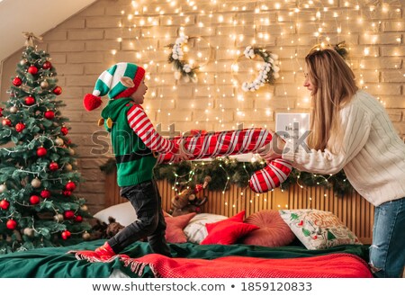 Foto stock: Boy Jumping On His Mothers Bed