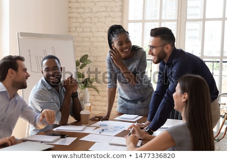 Foto stock: Joyful Multiracial Business Team At Work In Modern Office