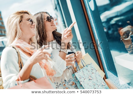 Stok fotoğraf: Women With Shopping Bags And Drinks In City