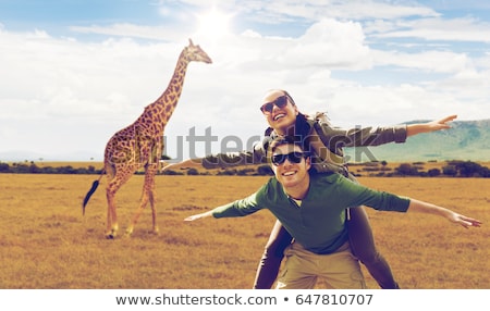 Foto d'archivio: Happy Woman With Backpack Over African Savannah