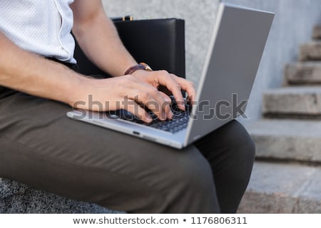 Сток-фото: Cropped Image Of Business Man With Briefcase Using Laptop Computer