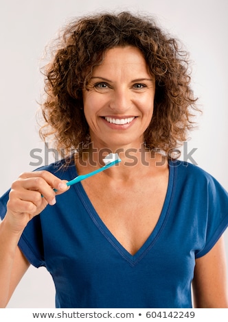 Stok fotoğraf: Pretty Middle Aged Woman Brushing Her Teeth