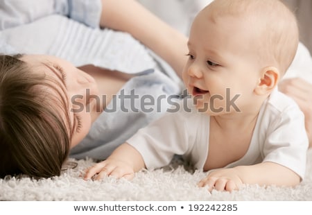 Foto stock: Close Up Of Family With Baby On Carpet