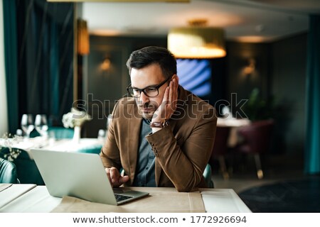 [[stock_photo]]: Portrait Of Tired Businessman Sitting In Restaurant