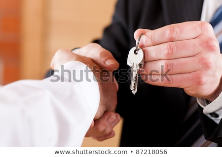 Business Handshake With Giving Keys Stockfoto © Kzenon