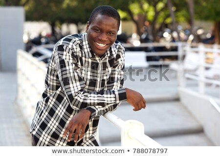 Stock fotó: Happy Young Casual Man Leaning On A Railing