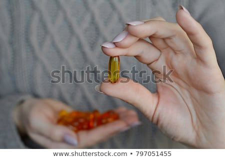 Stok fotoğraf: Omega 3 In Female Fingers