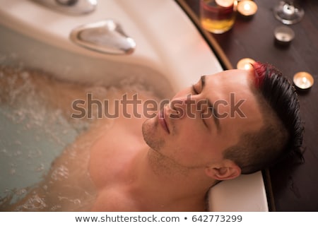 Foto stock: Handsome Young Man Relaxing In Hot Tub