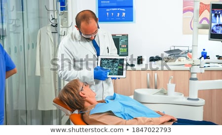 Сток-фото: Doctor Explaining X Ray Scan During Consultation