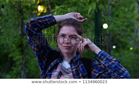 Stock photo: Emotions Pretty Woman Posing In Cage Outdoors
