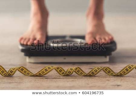 Stok fotoğraf: Sad Young Woman On Weight Scales