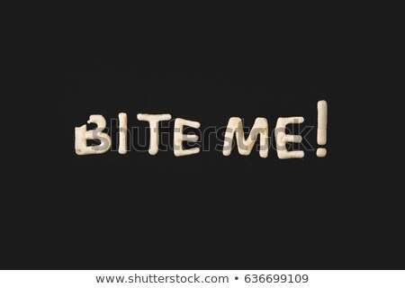 Zdjęcia stock: Top View Of Lettering Bite Me Made From Cookie Dough Isolated On Black