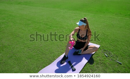 Stock fotó: Pretty Young Woman Having A Break During Exercise