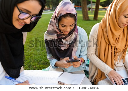 Stock photo: Arabian Women Students Using Mobile Phone In Park Outdoors