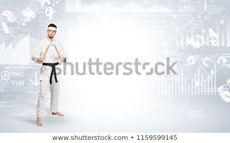 Zdjęcia stock: Karate Man Doing Karate Tricks On The Top Of A Metropolitan City