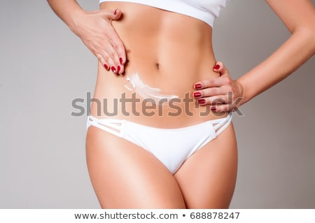 Stockfoto: Woman Apply Body Cream On Belly