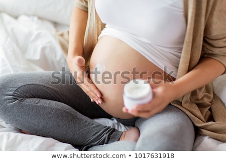 Foto stock: Pregnant Woman Moisturizing Belly
